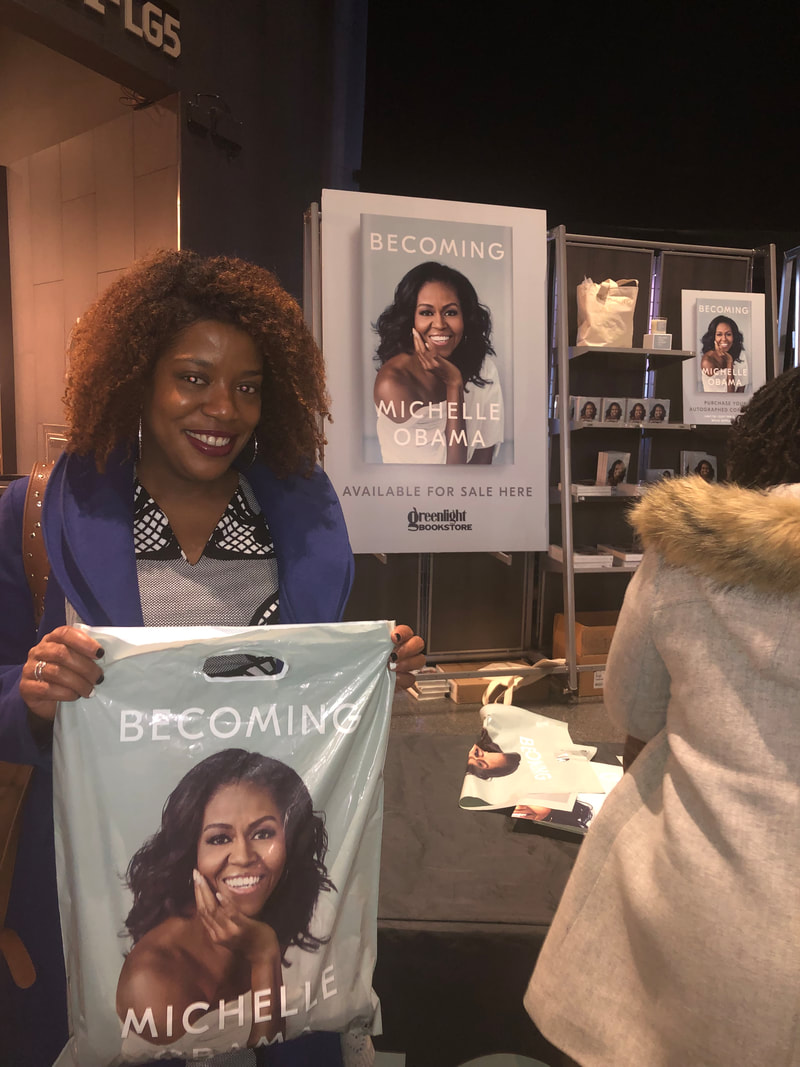 Jennifer D. Laws is inside Barclays Center purchasing merchandise at BECOMING: An Intimate Conversation with Michelle Obama on December 19, 2018. 