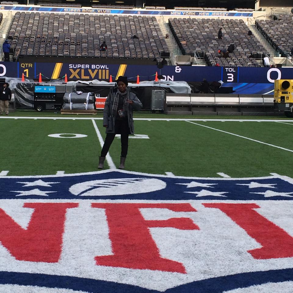 Jennifer D. Laws poses at the 50 yard line at MetLife Stadium the day before Super Bowl XLVIII. 